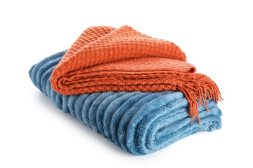Folded orange waffle knit blanket and blue ribbed fleece throw, cozy home textile stack for comfort and warmth, the soft fabrics provide a sense of relaxation and domestic comfort © Pixel-Shot