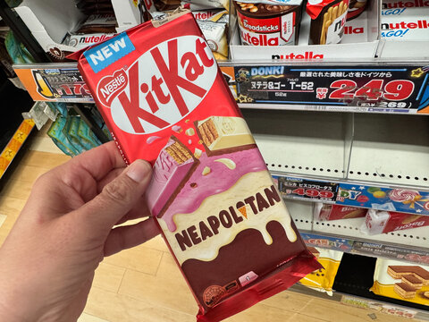 Hiroshima, Japan - April 20, 2026: Hand holds a neapolitan ice cream flavored Kit Kat candy bar