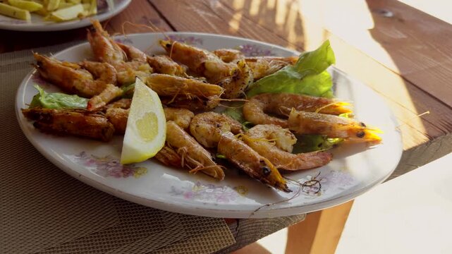 Fried Shrimps On Plate With Lettuce And Lemon Slice. Seafood Appetizer. Mediterranean Cuisine