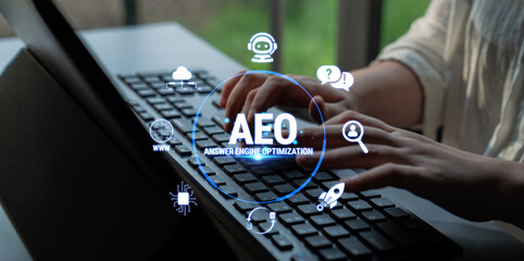 Obraz premium AEO Conceptual Visualization for Answer Engine Optimization with Hands on Keyboard and Digital Graphics Overlay in Soft Natural Light Fluxor.
