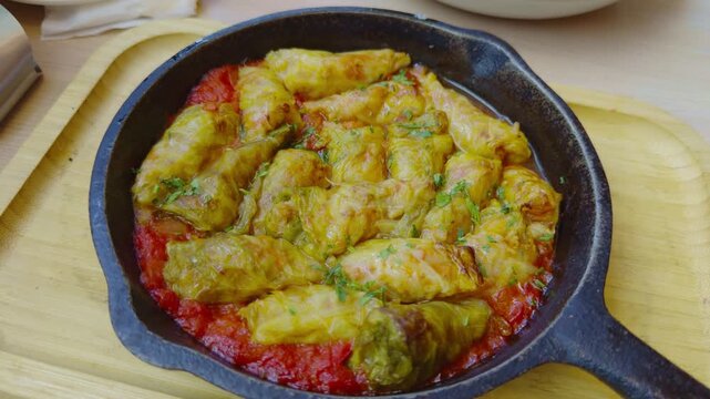 Stuffed Cabbage Rolls Baked With Minced Meat In Tomato Sauce In Black Cast Iron Skillet. Hot Homemade Food Dish