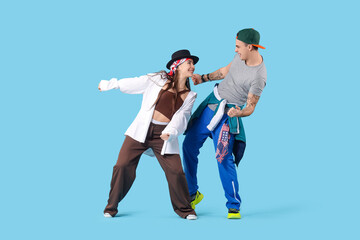 Couple of happy hip-hop dancers on blue background