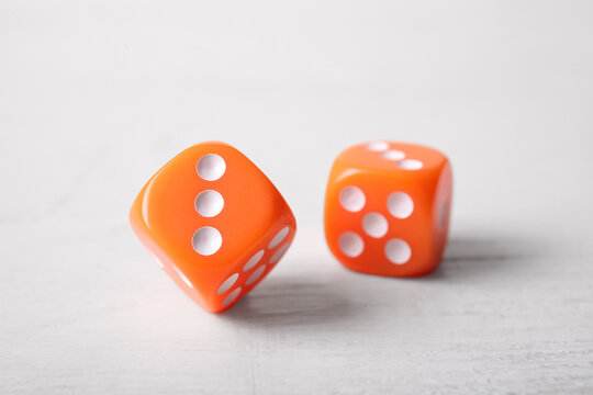 Orange game dices on white background