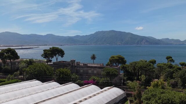 Panoramic view of Villa Rossi Filangieri historic building with pine trees overlooking Gulf of Naples and Sorrentine mountains, Torre Annunziata, Italy

