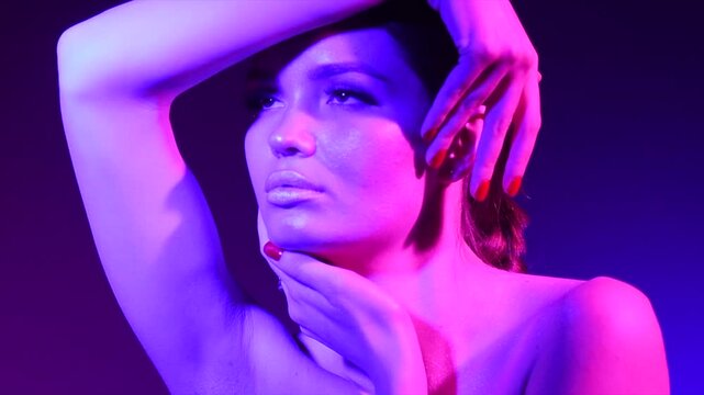 Colorful portrait of beauty sexy model girl. Beautiful woman posing. Gorgeous Brunette girl in neon light. Beauty Glamour sensual lady posing in vivid lights 