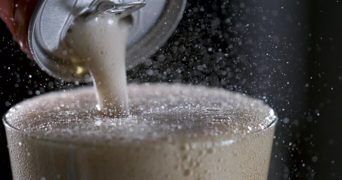 Foam and bubbles rise in slow motion from a poured drink