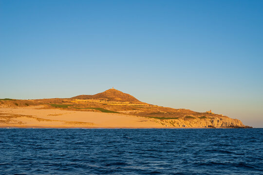 sandy shores of baja california pacific coast at los cabos and lighthouses in distance
