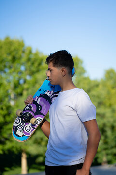 Young Person with a Skateboard in an Urban Park During an Outdoor Day