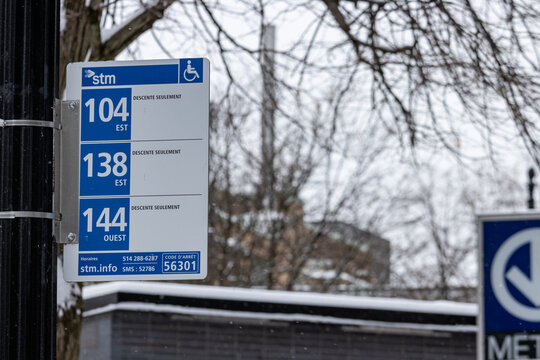 MONTREAL, CANADA, 25 December 2025 : Bus stop sign winter urban scene transportation accessibility icon trees background