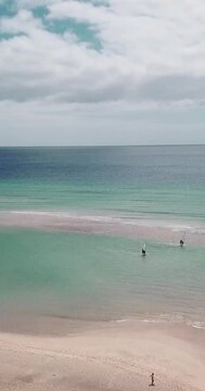 Amazing tropical beach anc blue transparent sea ocean water. Aerial view of coastline and amazing seascape landscape with horizon and sky and mountains in background. Summer travel