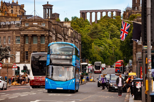 Blue double decker bus on busy Edinburgh street scene, Scotland