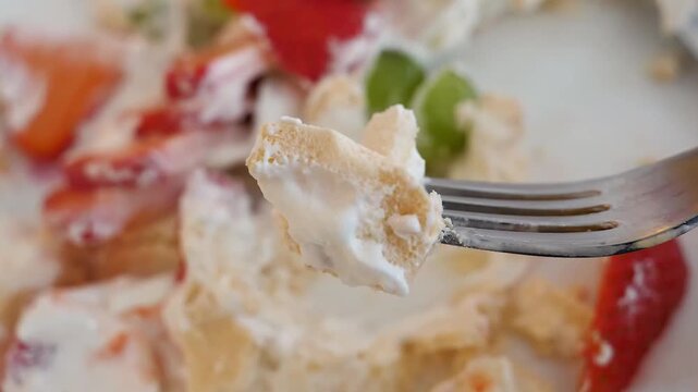 A close-up video of an unrecognizable person, wearing white gloves, skillfully slicing a ripe, orange-colored mango into cube shapes on a wet wooden cutting board. The juicy tropical fruit is prepared