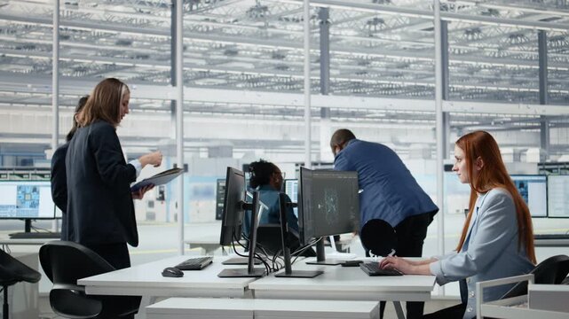 Women working in microchip factory lab training AI assistant to optimize hardware, female engineers in R&D office using AI to improve manufacturing efficiency for semiconductor research.