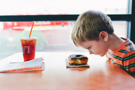 boy looking at doughnut