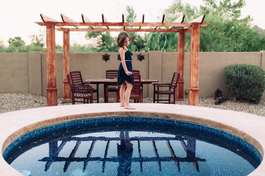 girl standing by pool, reflection