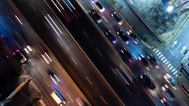 Aerial view of a busy highway at night with light trails from moving vehicles, captured from a high angle in the Dominican Republic.
