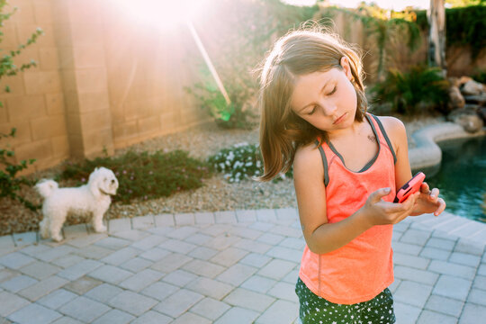 Girl with phone outdoors