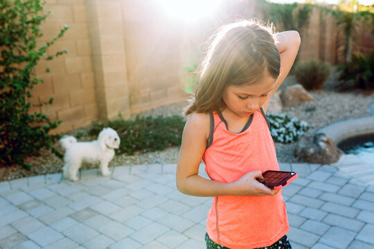 Girl looking at phone outside