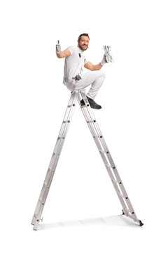 Worker sitting on a ladder with a throwel and gesturing thumbs up
