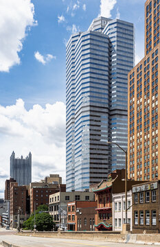Traditional Chinatown pagoda rooflines contrasting with the modern PWC tower in Pittsburgh