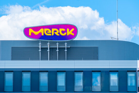 corporate Merck Group building facade, pharmaceutical headquarters architecture, Merck KGaA biotechnology company, science branding industry, Healthcare business infrastructure, Darmstadt, Germany