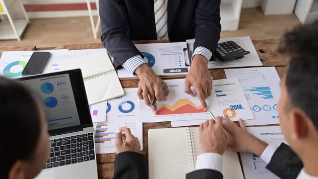 Business people analyzing business growth chart and discussing company strategy