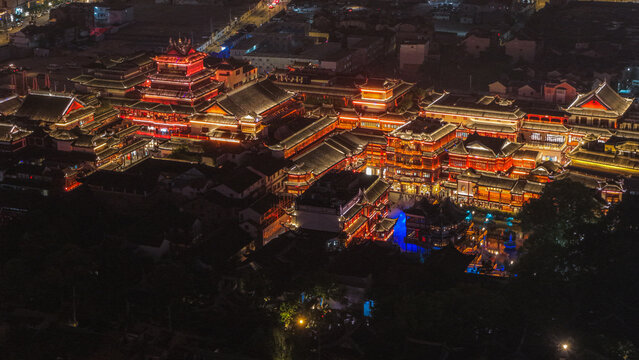 Aerial view of the illuminated traditional architecture of Yu Garden at night, featuring ornate rooftops and glowing lanterns in Shanghai, Shanghai, China.