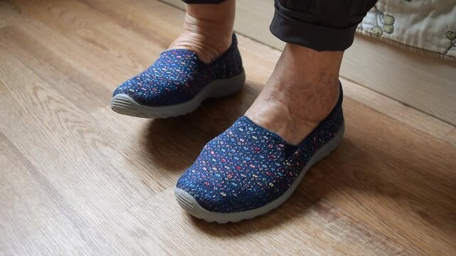 An elderly lady tries on new shoes