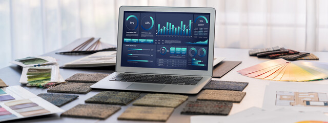 Fototapeta premium Interior designer workspace table and architecture software on laptop screen with mood board materials and colorful swatch color for color selection. Modern interior design office. Insight