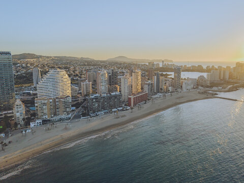 Aerial view of high-rise buildings along the sandy beach and Mediterranean Sea in Calp, Valencian Community, Spain.