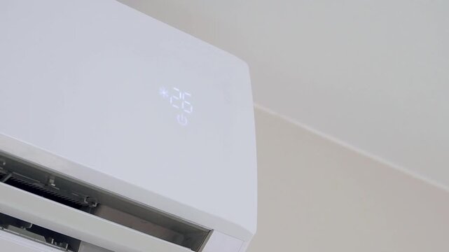Air conditioner display shows changing temperature in cooling mode footage