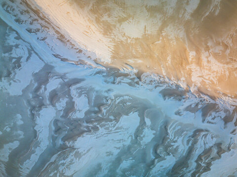 Aerial view of the sandy coastline and intricate tidal patterns at Two Peoples Bay Nature Reserve in Nanarup, Western Australia, Australia.