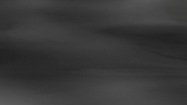 Strong wind blows white smoke into thin streaky trails sweeping across frame.
