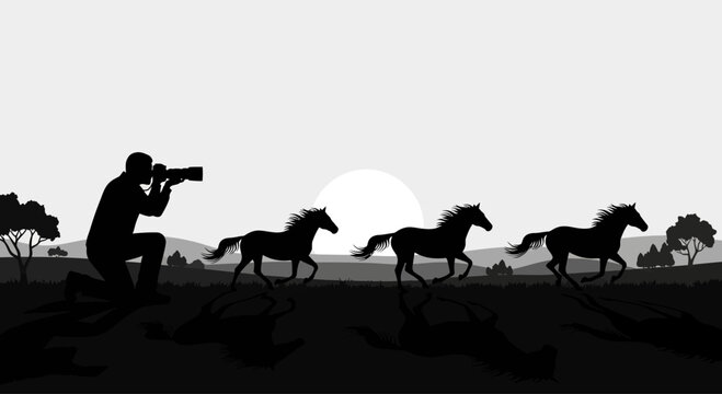 A photographer capturing a silhouette of three horses running in a field.