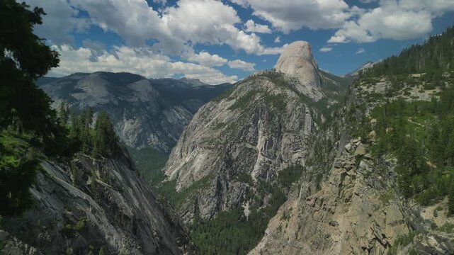 Aerial view of Yosemite Valley showcasing dramatic granite cliffs, lush forests, and winding river under natural daylight in California&rsquo;s Sierra Nevada.