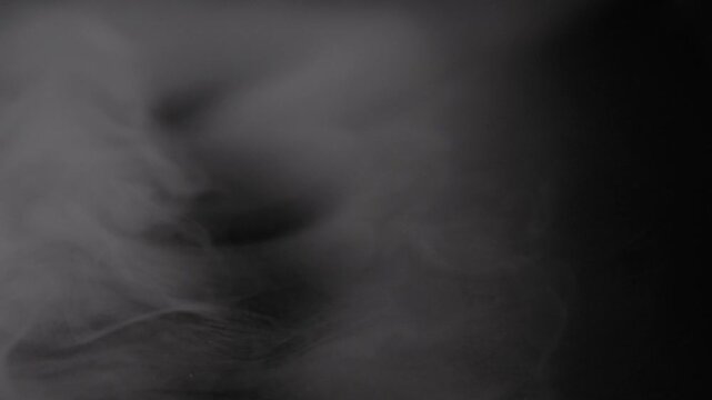 Thick white smoke surges continuously into frame from the left side.