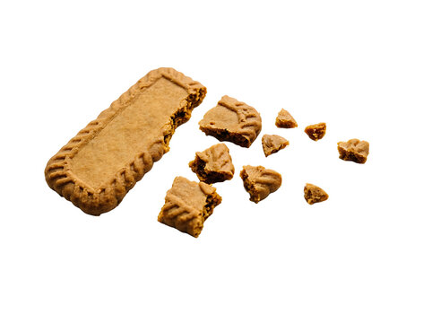 A broken biscoff cookie on a transparent background with chunks scattered around it, isolated on transparent background