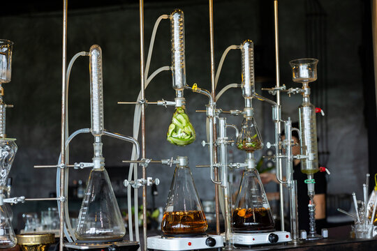 Distillation apparatus laboratory glassware gin distillation alcohol distillation scientific experiment clear liquid brown liquid chemistry equipment industrial process