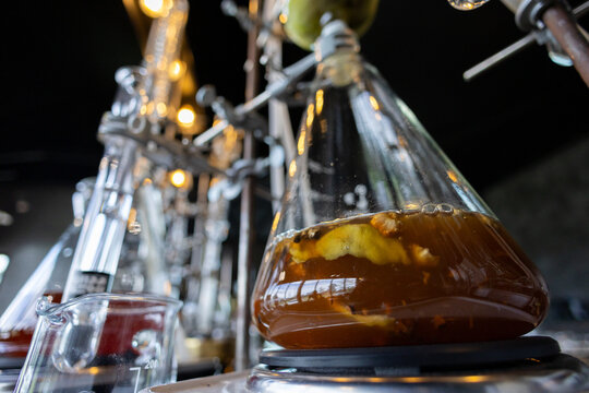 Distillation laboratory glassware liquid fermentation science chemistry alcohol equipment process experiment transparent brown flask industrial closeup research technology scientific production