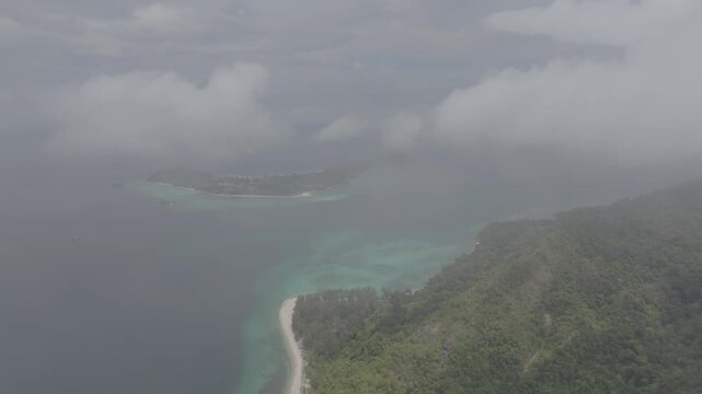 Aerial drone view of Koh Lipe island, Satun, Thailand. Turquoise sea, coral reefs, white sand beaches and traditional long-tail boats in the Andaman Sea.