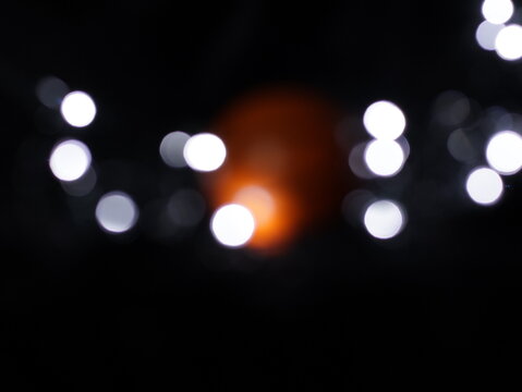 Un fondo abstracto de luces de navidad de diferentes colores en la oscuridad. Desenfoque bokeh