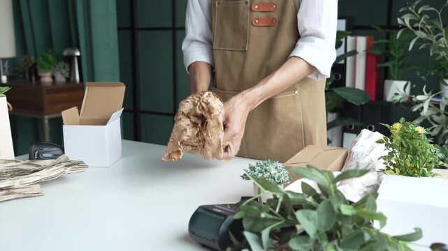 Asian business owner packaging with eco bubble wrap