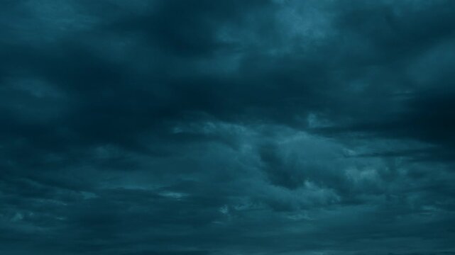 Night storm clouds forming from thick overcast sky before rain.
