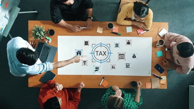Team Collaboration on Tax Planning Strategies Around Table with Documents and Laptops in Modern Office Setting Gluon.