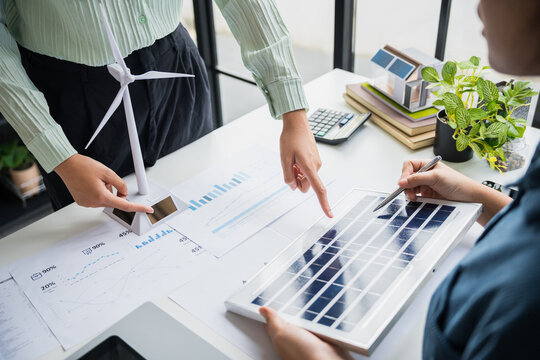 Solar panels green energy Business people working in green eco friendly office business meeting creative ideas for business eco friendly professional teaching corporate people sustainable electricity