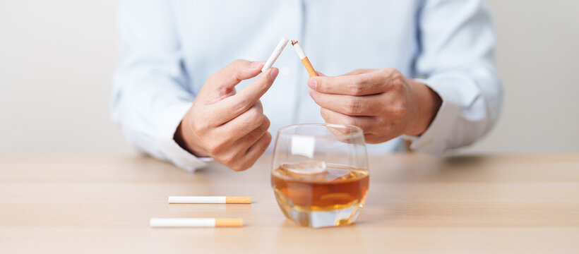 Man hand break and stop gesture to refuse cigarette and glass of Whisky, for say no to alcohol drink and for World No Tobacco Day, quitting smoking to prevent Lung Cancer and stop nicotine addiction