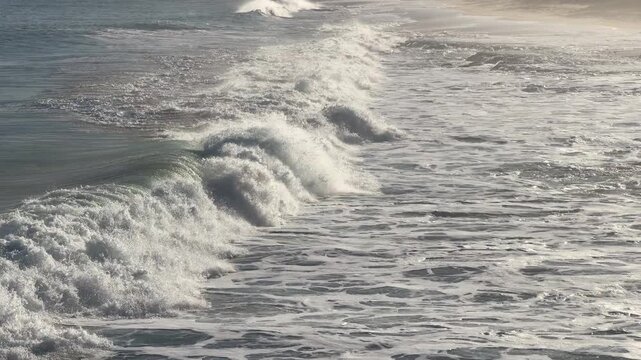Ocean waves break and crash onto the shore in Port Elliot South Australia in 4k video footage at 60 FPS