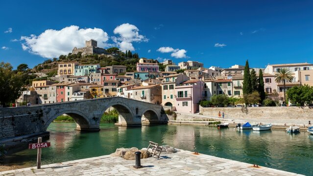 Colorful houses and stone bridge in bosa, sardinia, italy