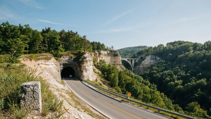 Naklejka premium Scenic road with tunnel and bridge through limestone cliffs