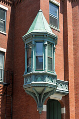 Historic oriel bay window on a brick building in direct sunlight, Charlestown, Boston  © Baharlou